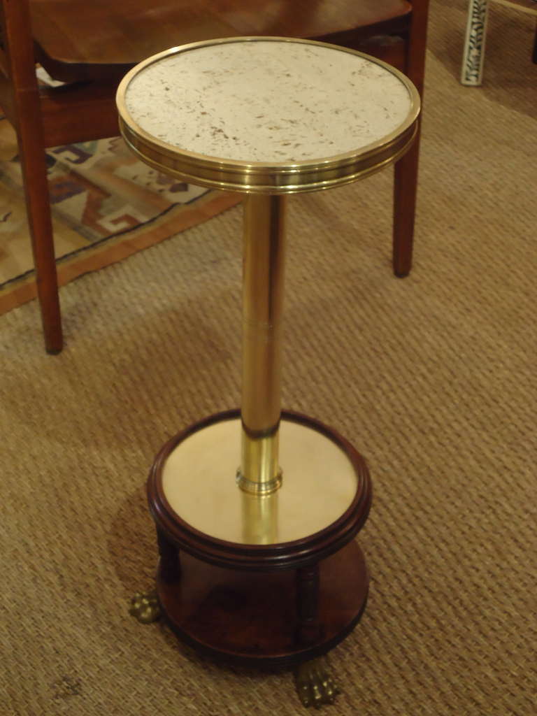 Elegant and functional drink stand, travertine top, brass paw feet, mahogany.