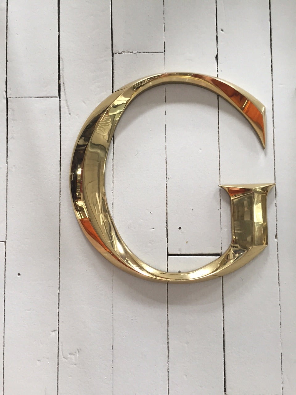 Solid brass letters that spell Gucci ; from one of their retail stores.
Each letter has holes to allow for mounting.