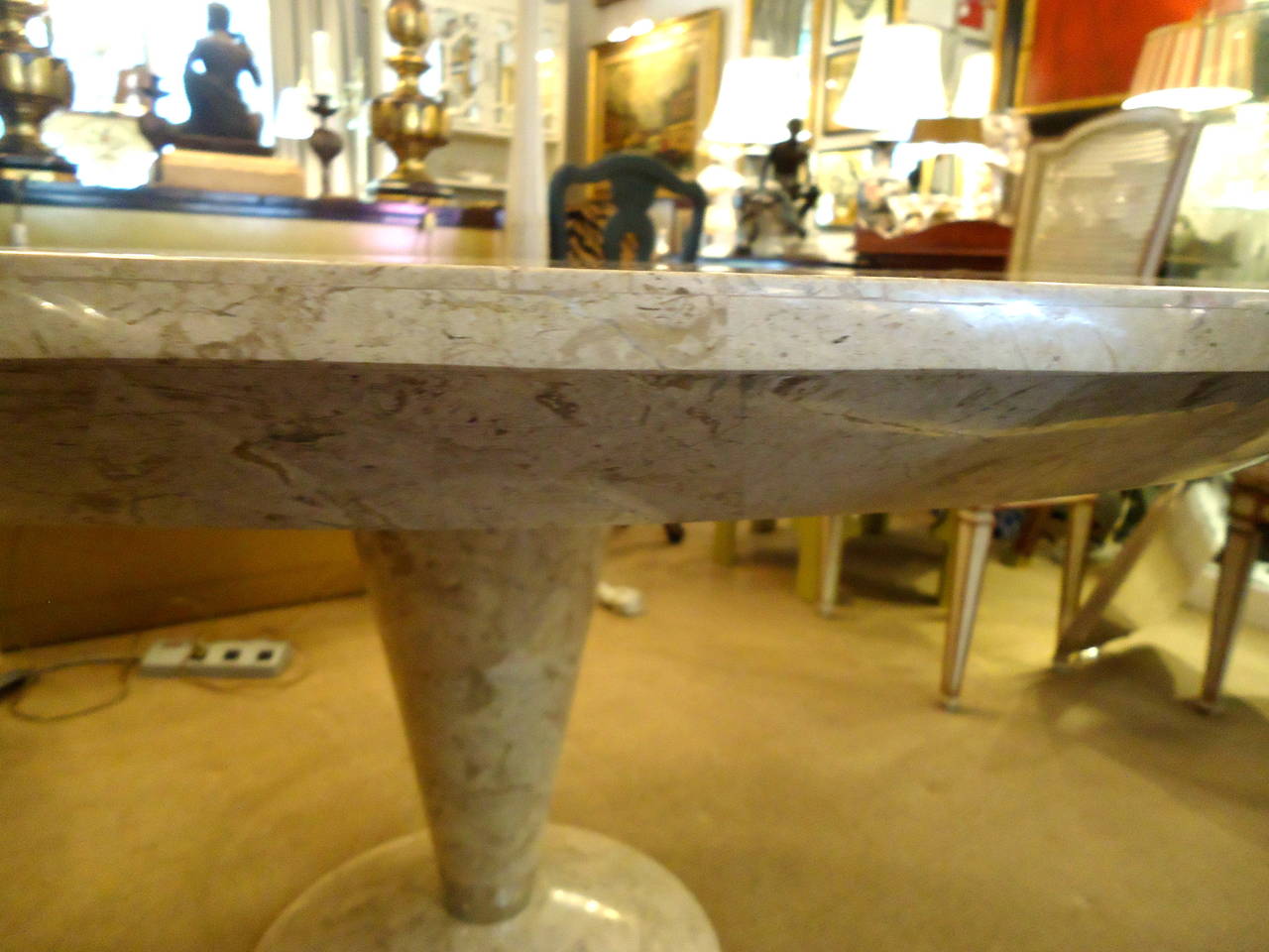 Italian travertine veneer or tessellated stone round table with elegantly tapered pedestal base.