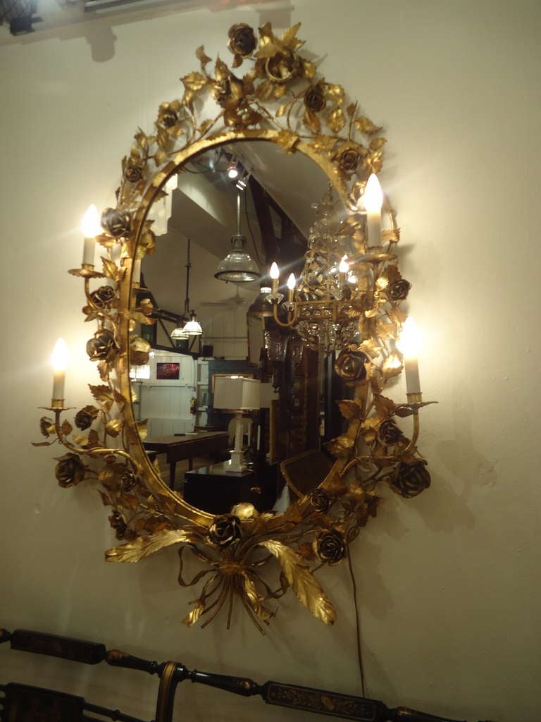 Very unusual vintage oval mirror, glamorous and ornately decorative, gold roses and a bird's nest with little bird resting in it adorn the periphery.  Four electrified sconces. 
(can take 60 w each)