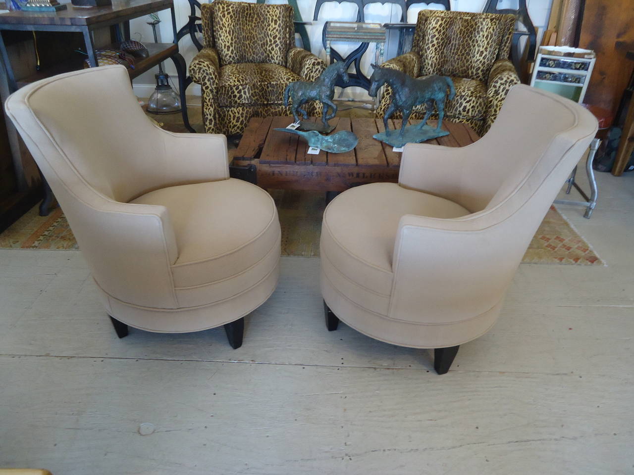 Sophisticated and tailored tub chairs having ebonized legs and new camel hair upholstery reminiscent of a gentleman's overcoat, plus they swivel smooth as silk.
