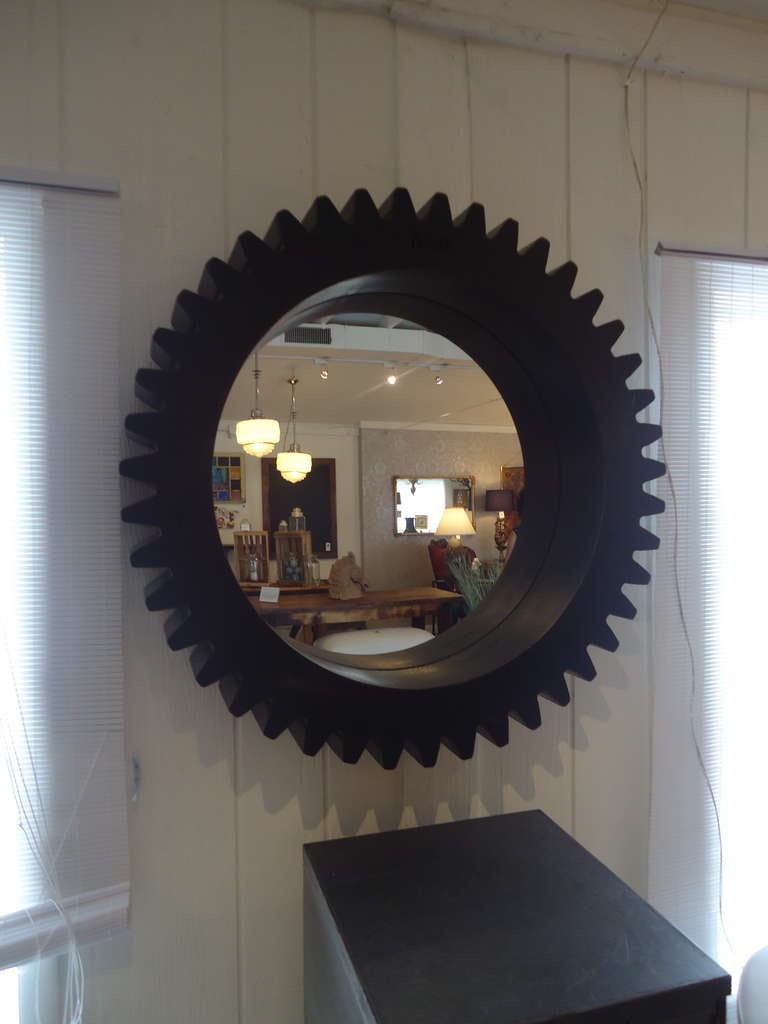 Very thick, black wooden gear outfitted with a mirror.
Wonderful focal point.  Has engraved industrial numbers.
6