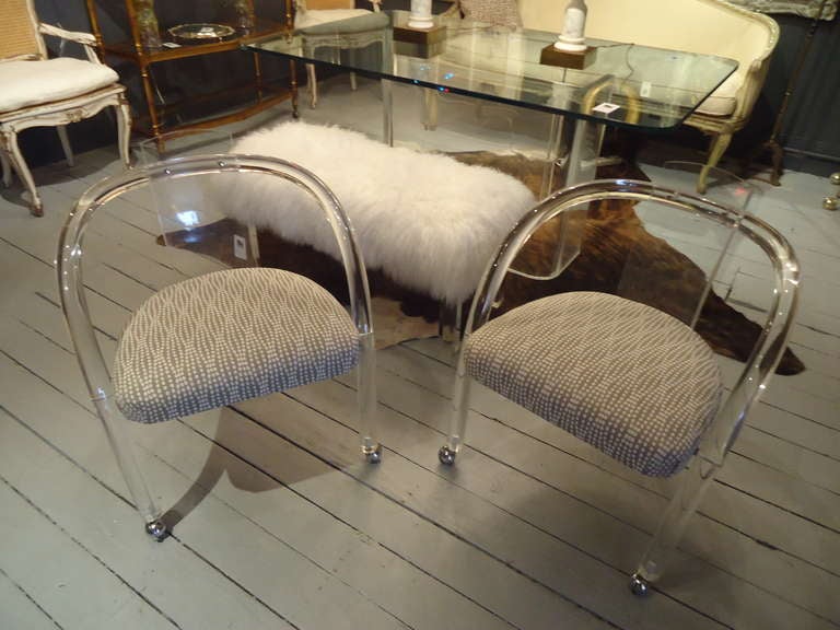 Sleek lucite, curved back and arms, newly upholstered seats.  

30