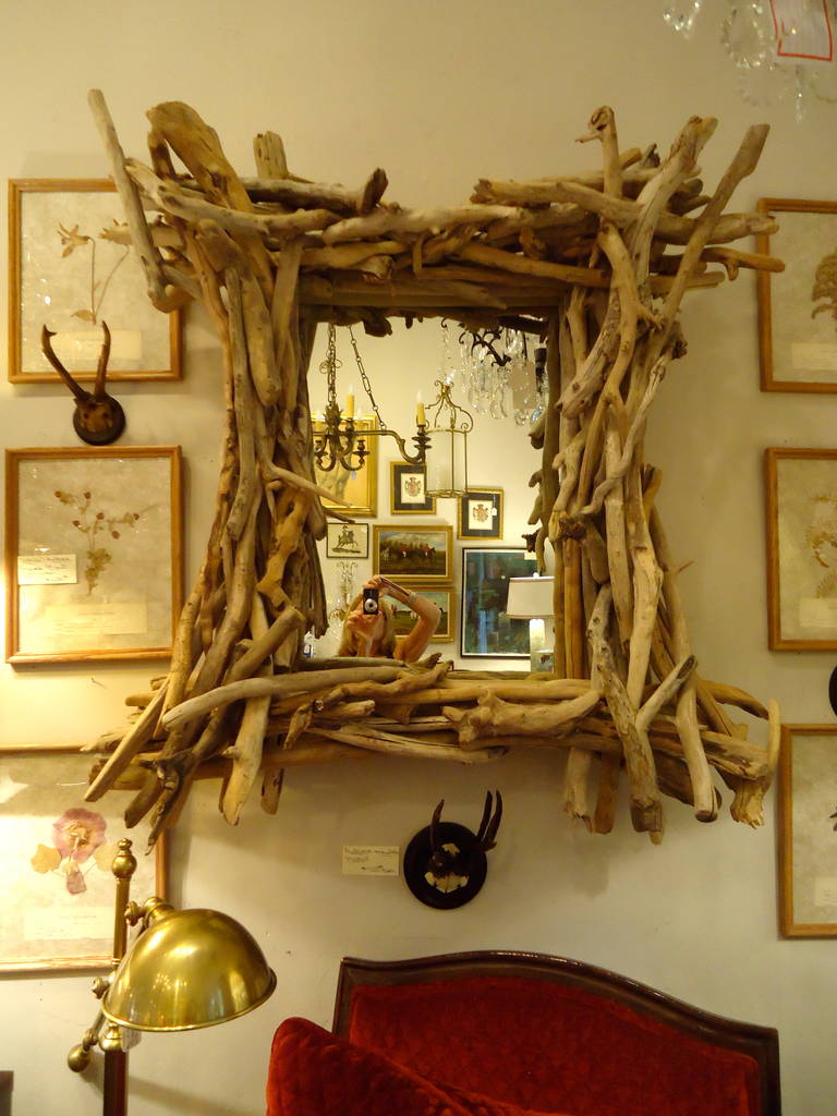 Large and attention worthy organic creation of driftwood twigs, multilayered and beautifully arranged around a rectangular mirror. A focal point.