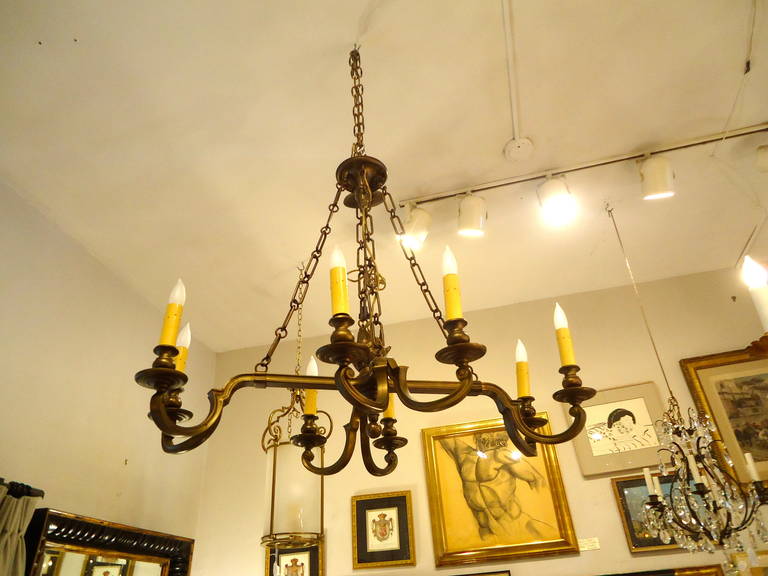 NeoClassical Style, Bronze chandelier by Chapman.  Lovely bronze flame sits in the center of this impressive eight  arm fixture.  The 