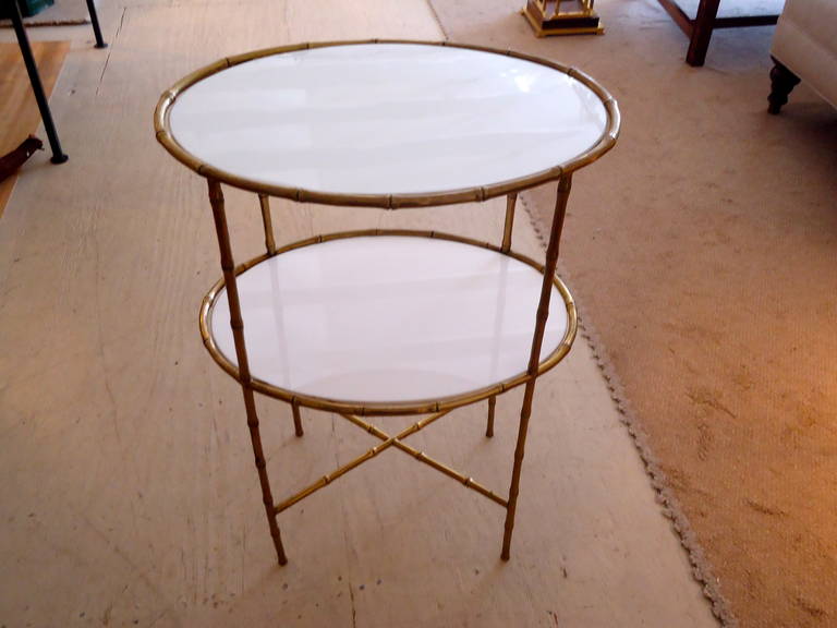 Faux bamboo bronze with two oval milk glass inserts makes a sophisticated elegant side table.  Attributed to Maison Bagues.
Lower shelf is 16.5