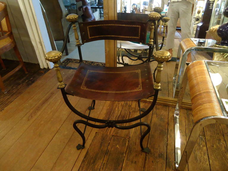 A particularly fetching version of this classic design, four handsome round decorative finials, tooled leather seat and back and curvy wrought iron base.
Missing two screws in the seat.