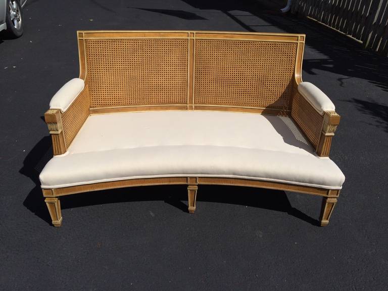 In the French manner, a rare pair of curved settees with gorgeous caned backs, carved gilded wood with a hint of old paint. Newly refurbished in white duck with a single seat cushion and two back cushions.
54