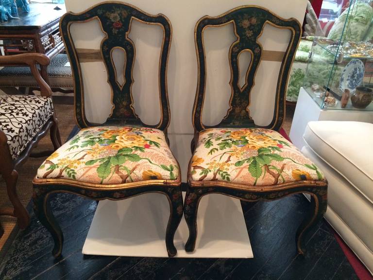 Exquisite side chairs, with a dark hunter green background and hand-painted flowers, gold leaf edges. Wonderful chintz print by Colfax and Fowler on the seats.