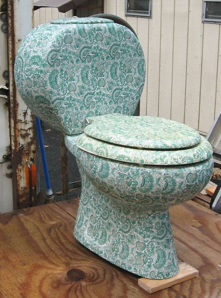 A wonderfully decorative and functional toilet covered with paisley.   Measures 18