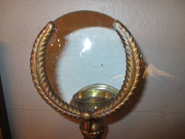 Vintage brass Regency style candle sconces with interesting magnifying 
lenses.