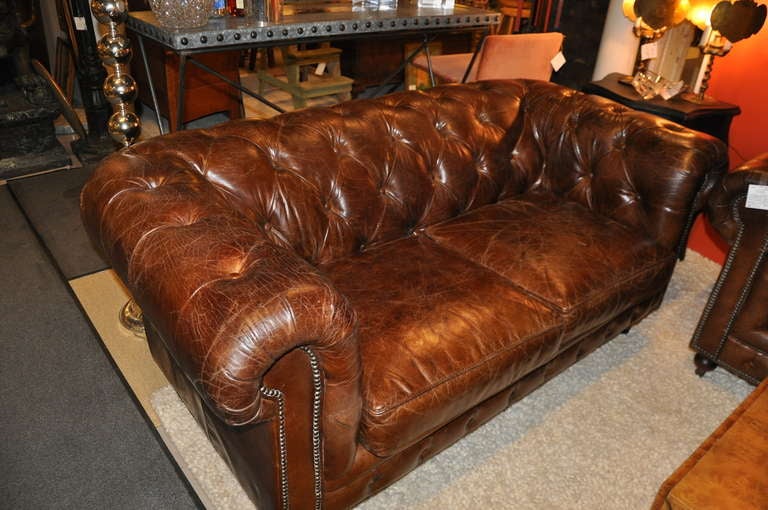 Distressed leather with wonderful patina, rich brown, tufted with nailhead trim.
Will sell individually for $3800/ each
 Depth of seat cushion. 21.5