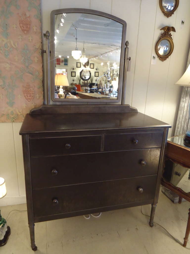 Very handsome metal commode with attachable mirror.  Two small drawers on top, two large drawers below.  On wheels.
Height of surface top of commode is 35.75
