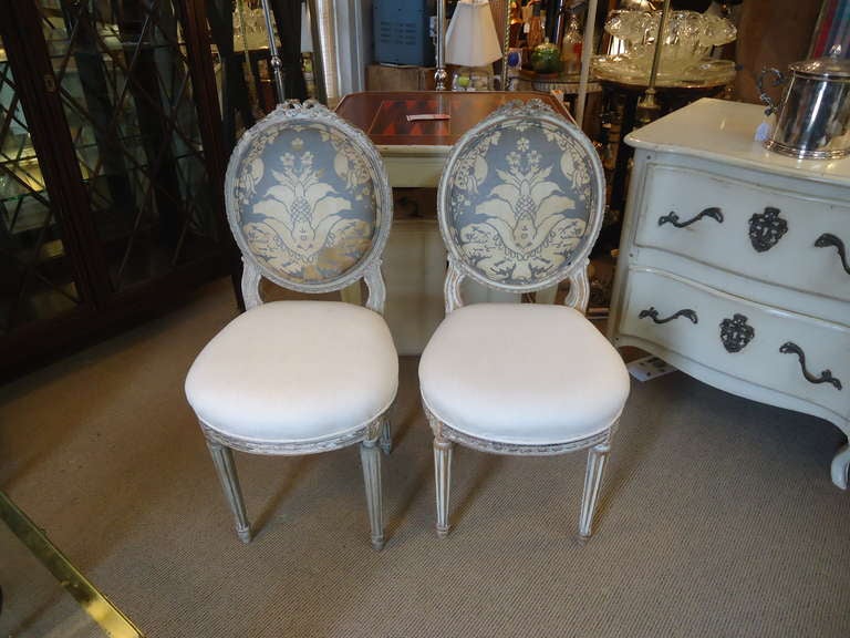 Pretty, pale grey, original chippy paint, carved wood frames with bow. Newly upholstered seat in creamy linen backs are original fortuny but stained.
Measures: Top backs are 14