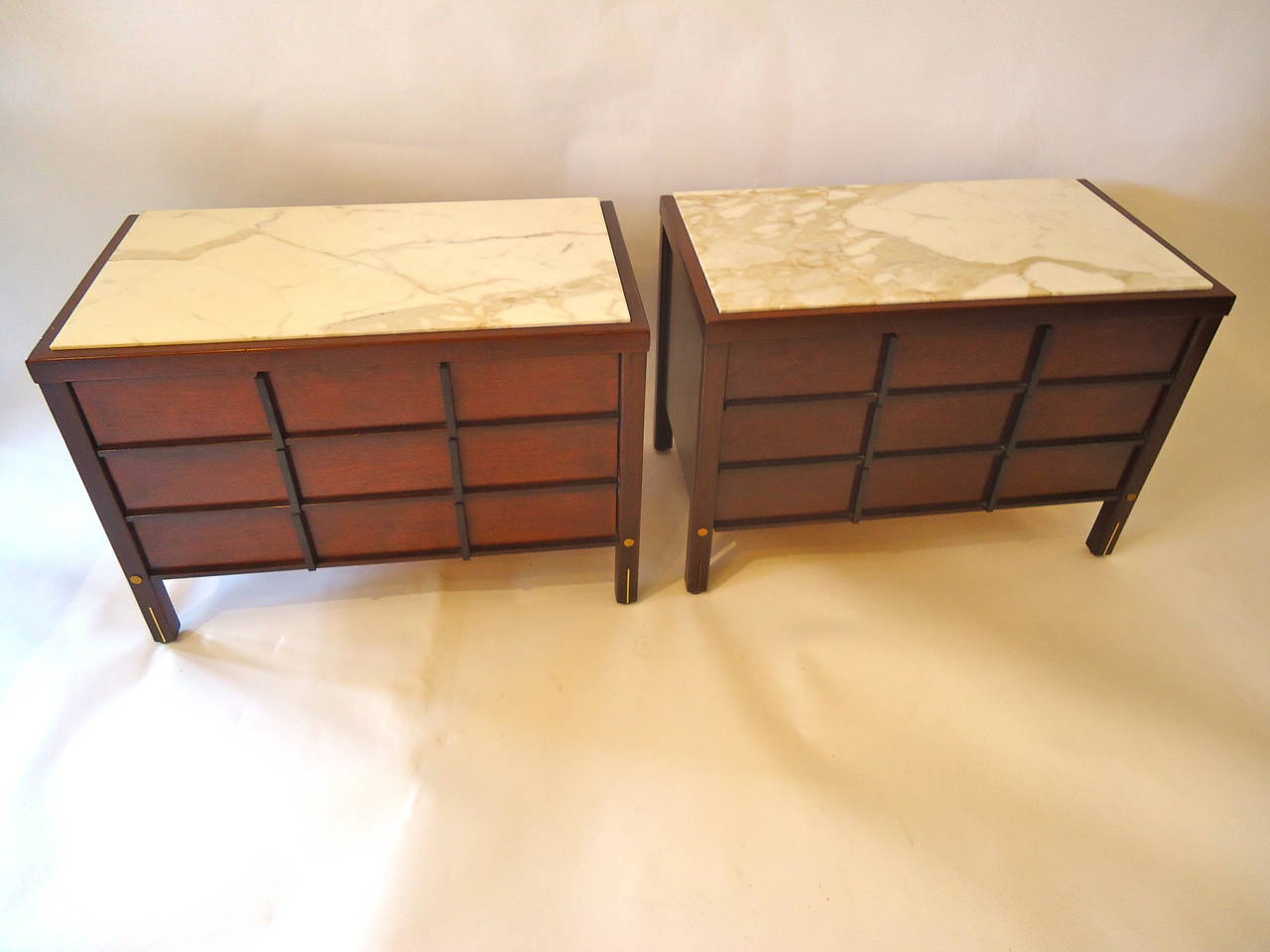 Beautiful midcentury modern endtables or nightstands in dark mahogany with creamy marble tops.  3 Drawers in each and cool brass detailing on the front of legs.