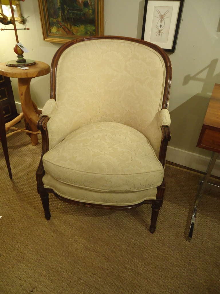 Refined and elegant armchair, neutral cream patterned fabric, down cushion.  Carved mahogany or walnut.
Seat depth 22