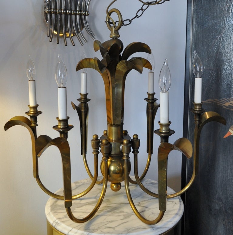 Stunning six arm solid brass palm style chandelier.
Includes original ceiling cap and about 21 inch long chain.







 