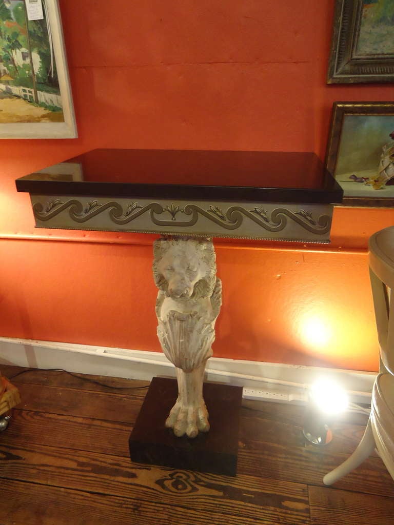 Antique lion fragments from Florence, later converted to consoles with faux marble bases and tops.
 A scroll design and beading adorn the sides. The base of each is a cement lion with one paw foot, which also rests on a square slab of black faux