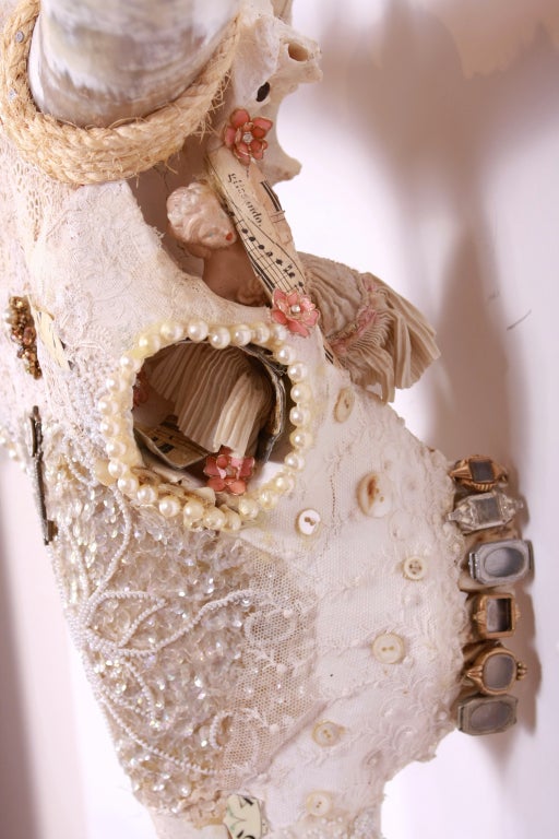 Mixed media wall sculpture on skull incorporating antique ephemera.  
1 in a series of 6 by reknowned artist Fay Sciarra.