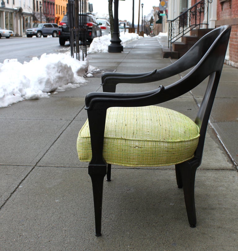Pair of upholstered, spoon back armchairs c. 1940. Fabric c. 1960s.
Ebonized mahogany frame. Stylized dolphin head carved arms