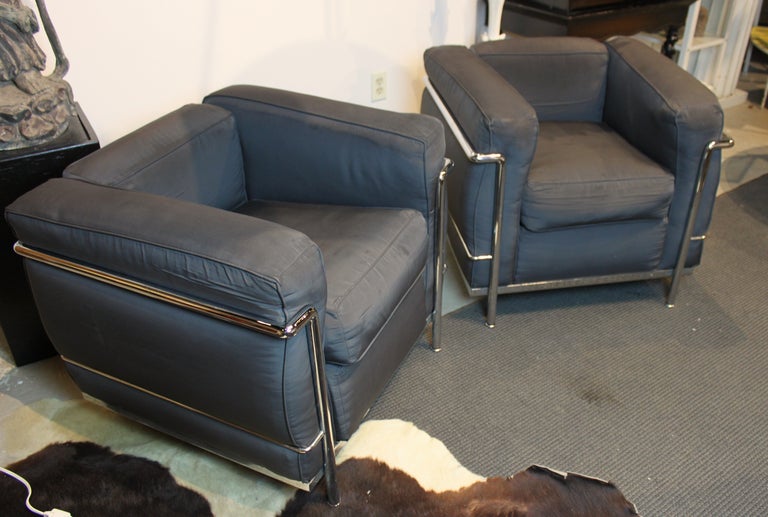 Pair of Le Corbusier LC2 cube chairs with polished nickel frames and black cloth upholstery. Made by Cassina. c. 1970