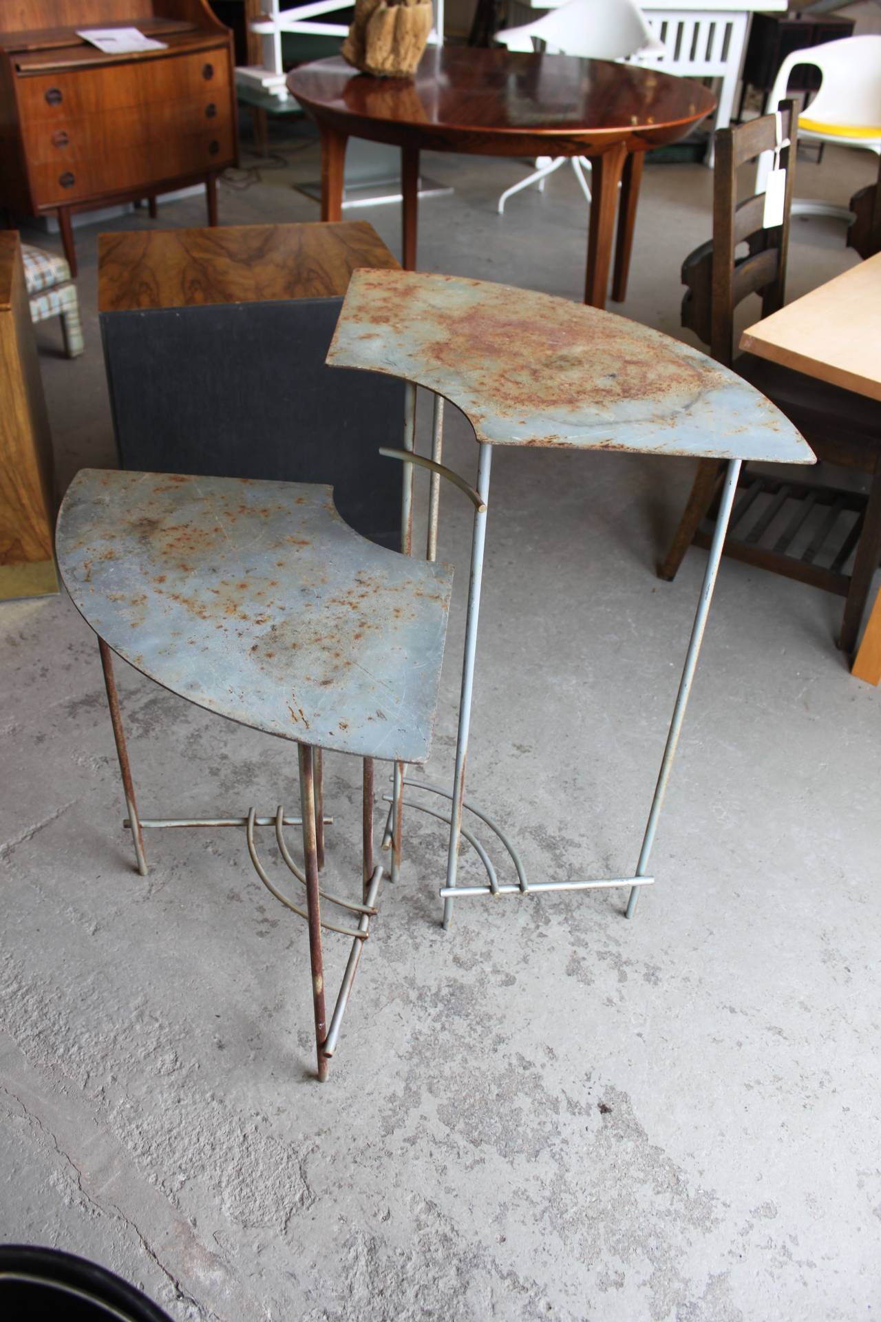 Complimentary pair of vintage plant stands metal tables. Curved fan like design. Rust stains all-over otherwise in very good shape.