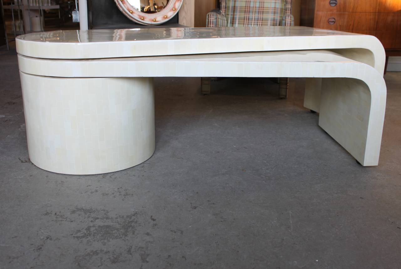 Tessellated bone waterfall swivel extending coffee table. Raised surface on random areas on the top of the table but overall considered to be in very good shape.  