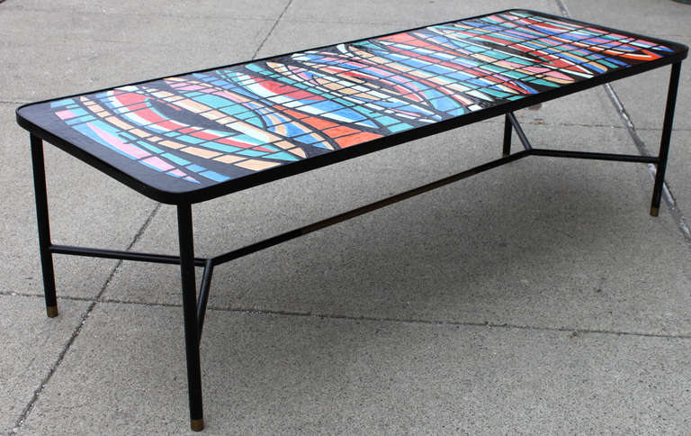 Italian 1950's enameled coffee table with brass sabots and brass detail on stretcher.
