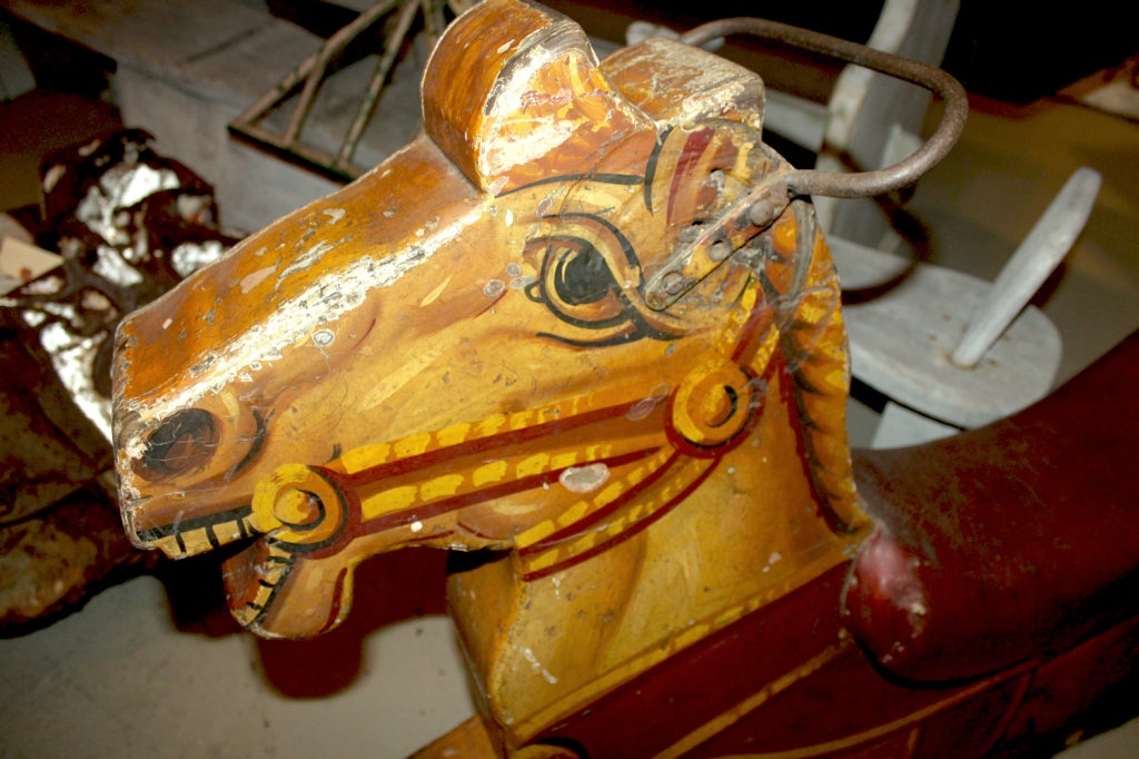 From Stephanie Lloyd, a charming riding horse. Once part of a child's mechanical amusement ride, it would have featured 3 or 4 horses which would have circled around upon the deposit of a coin. The beautifully-detailed paint design is amazingly