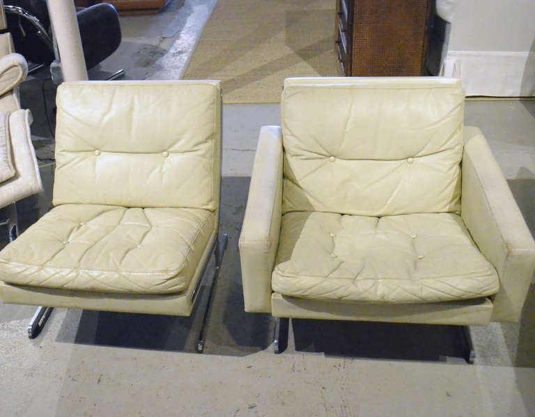 Modern white leather chairs. circa 1970s. Beautifully worn in ivory color leather with contouring chrome base. Stunning! Very heavy.