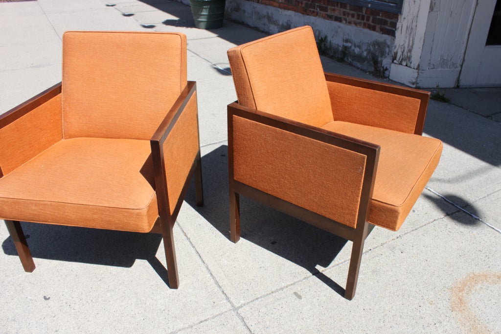 A handsome pair of walnut framed upholstered arm chairs by Stow Davis in original fabric.