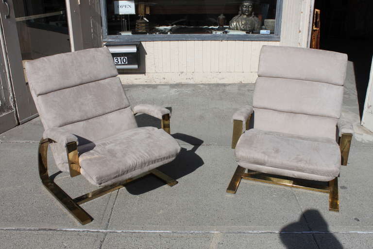 Nice and solid pair of Milo Baughman style lounge chairs in brass finish. Ultra-suede upholstery in good condition.