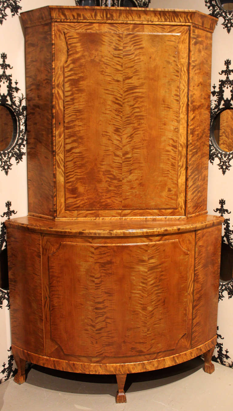 Burl and tiger maple corner cupboard.

Includes keys for both top and bottom doors, three removable shelves for the top cabinet and one removable shelf for the bottom cabinet.