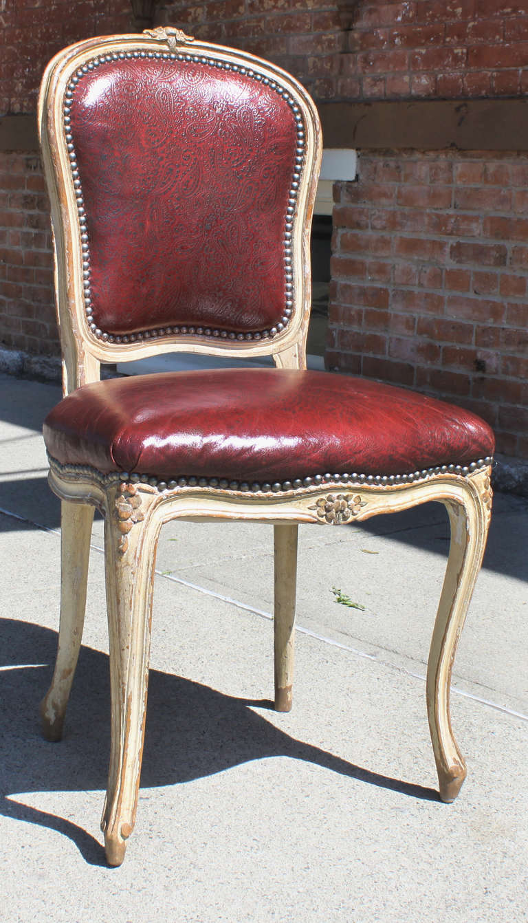 Set of four Louis XV style side chairs with embossed vinyl paisley upholstery.