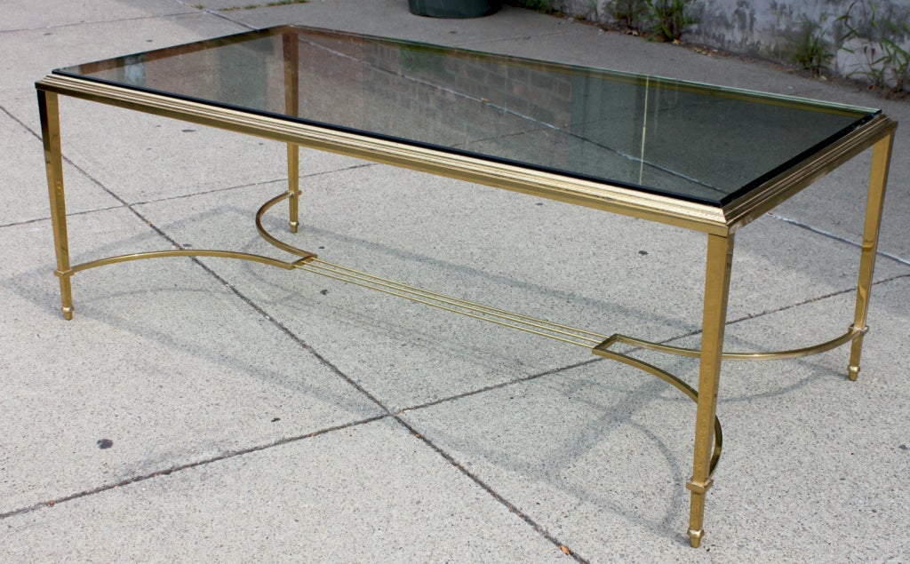 Neoclassical 1950's well-made glass and brass coffee table. Table is very heavy for its delicate look.