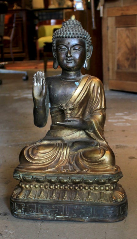 Chinese Buddha from the 1900's. Wonderful patina, holding a lotus flower which could be used for incense.