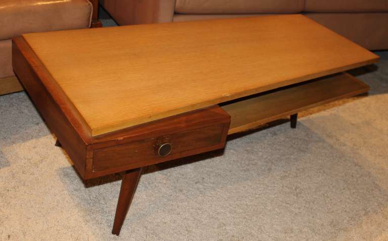 Beautiful Jetson style coffee table. Awesome Mid-Century design. One drawer can be pulled out from either side. Two-tier design.