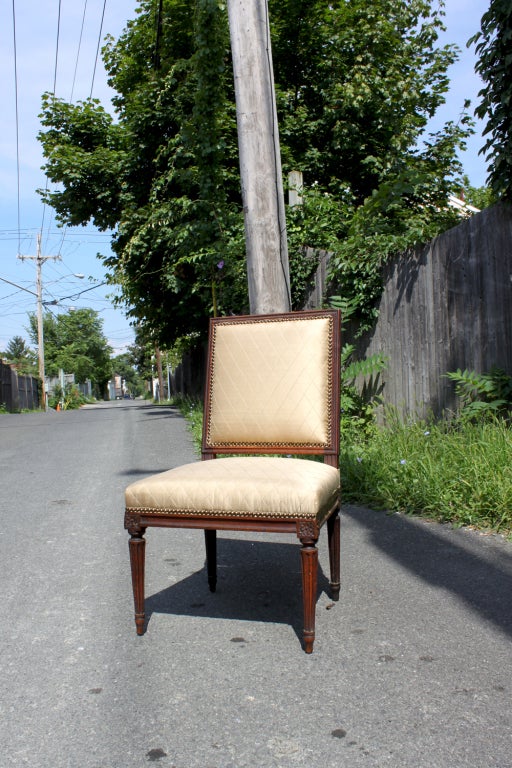 Louis XVI side chair with rectangular back and reeded tapering legs.
