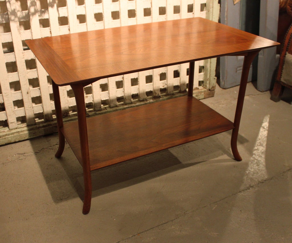 T.H. Robsjohn-Gibbings walnut end table with banded top and lower shelf.