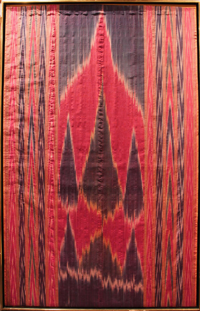 A bold geometric patterned Ikat tapestry. Naturally died silk in deep crimson and magenta hues. Archivally mounted and framed.

Provenance: Salander - O'Reilly Galleries NYC