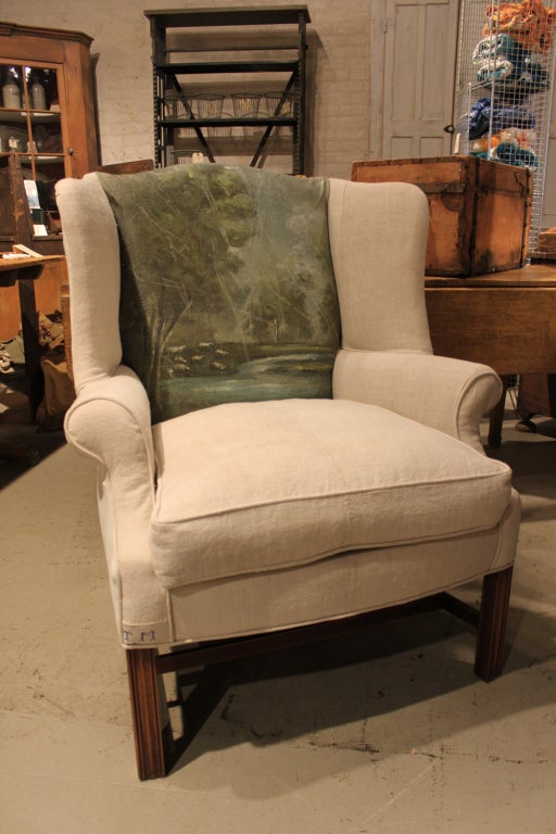 From Stephanie Lloyd, a bespoke wing chair. Original artwork, vintage French linen, vintage frame and all new upholstery materials underneath.

Ottoman no longer available