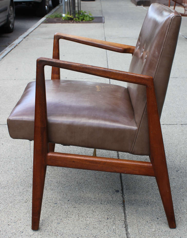 Classic Jens Risom arm chair for Jens Risom Inc. Walnut frame with a leather seat and back adorned with three buttons. Nice aging to the leather. There are three of the leather available.