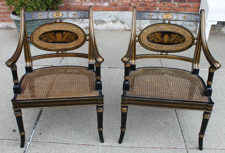 Beautiful pair of Regency style ebonized and gilt armchairs by Maitland Smith. Minor nicks on the chairs but overall in very good condition.