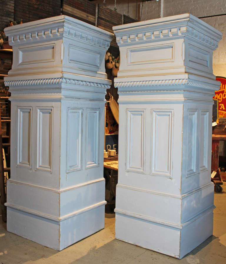 Large scale column form cabinets. Most likely store display with storage. Each paneled and trimmed on two sides and bead board on subsequent sides.  Multiple layers of paint in the off white family. Would make fabulous room divider or display case