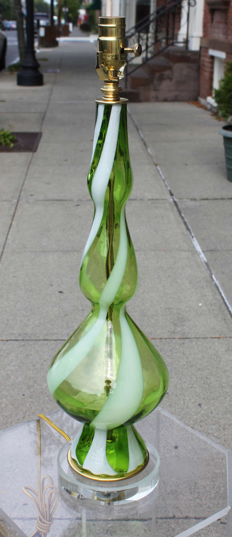 A crisp green glass blown with a white ribbon twist in a descending bell shape. Newly retired with silk cord and new brass socket.
