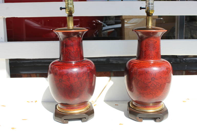 Beautiful vintage pair of Chinese ox blood lamps. Brass and walnut fittings.  In excellent vintage condition.

Height of base to the top of the porcelain vase is 14.25