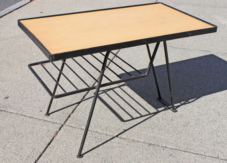 Great mid 20th century iron table by Arthur Umanoff. Square stock iron framing with blond wood top and iron shelf.
