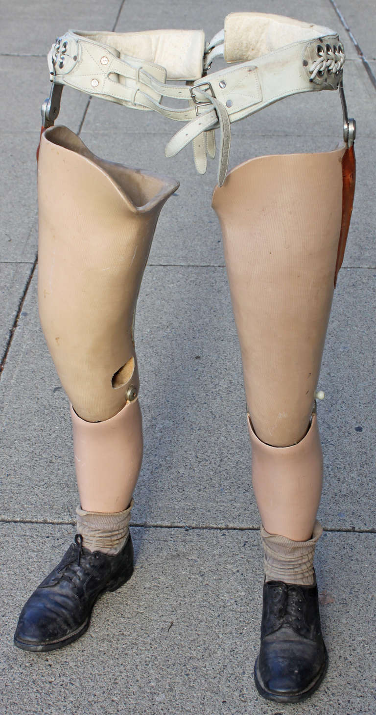 Vintage set of above the knee prosthetics complete with waist belt and shoes.