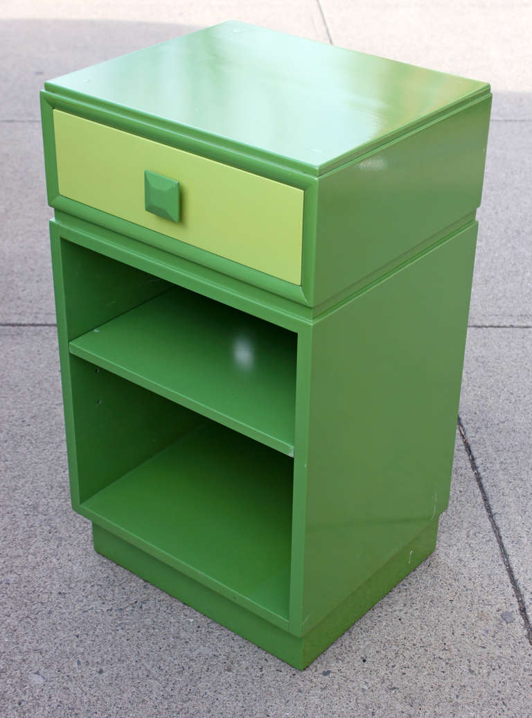 Great pair of 1940's side tables with drawer. The two tone finish in true avocado appears to be factory done and virtually pristine with only a few minor scratches. Shelf is adjustable. Both drawers marked with branded label.

Also available, pair