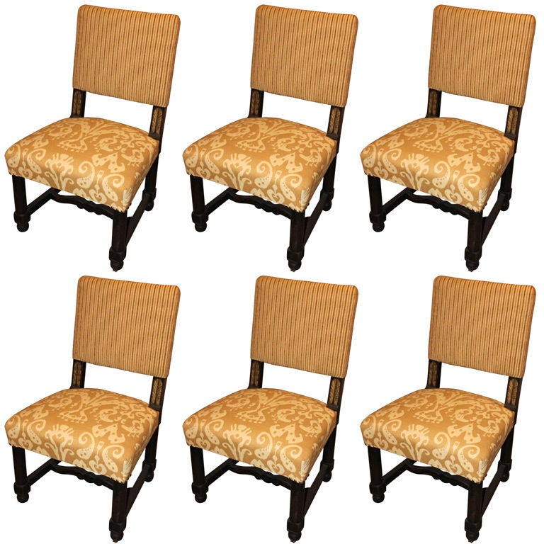 Set of 6 American oak lacquer and gilt dining chairs. Working recessed wheels inside front legs. New upholstery, cut velvet stripe on back and a woven cotton/linen on seat. Subtle corner nail head trim.